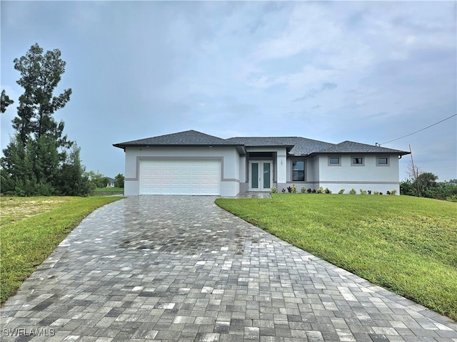 view of front of home featuring a garage and a front yard