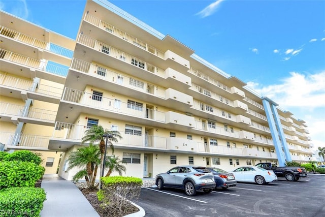 view of property featuring uncovered parking