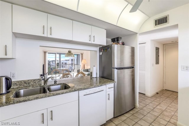 kitchen with visible vents, dishwasher, freestanding refrigerator, white cabinetry, and a sink