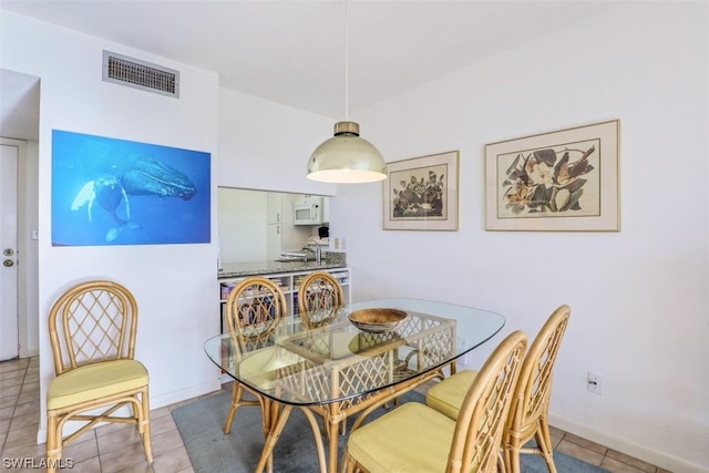 dining space featuring tile patterned floors and visible vents