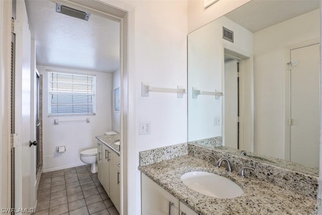 bathroom featuring tile patterned flooring, visible vents, baseboards, toilet, and vanity