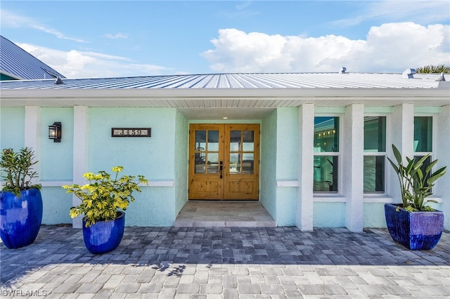 view of exterior entry featuring french doors