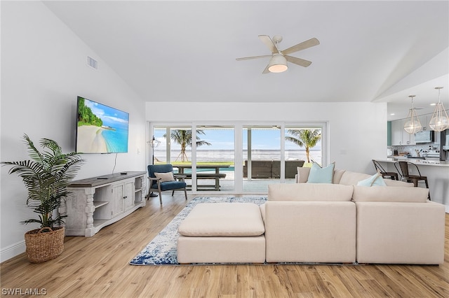 living room featuring high vaulted ceiling, ceiling fan, and light wood-type flooring