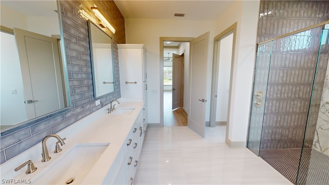 bathroom with oversized vanity, tile floors, dual sinks, and walk in shower