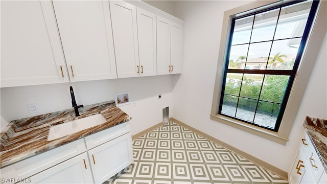 washroom featuring hookup for a washing machine, hookup for an electric dryer, cabinets, and sink