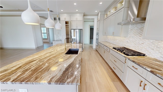 kitchen with wall chimney range hood, tasteful backsplash, stainless steel fridge with ice dispenser, and white cabinets