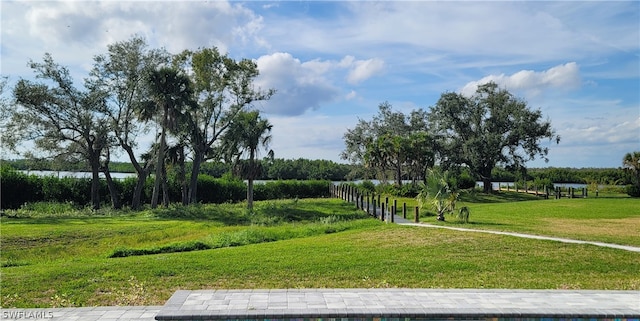 surrounding community featuring a lawn and a rural view