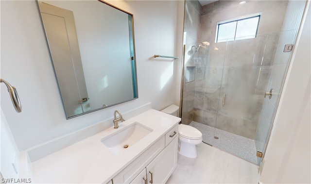 bathroom with vanity, toilet, and walk in shower