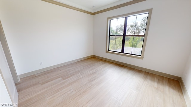 unfurnished room featuring ornamental molding and light hardwood / wood-style floors