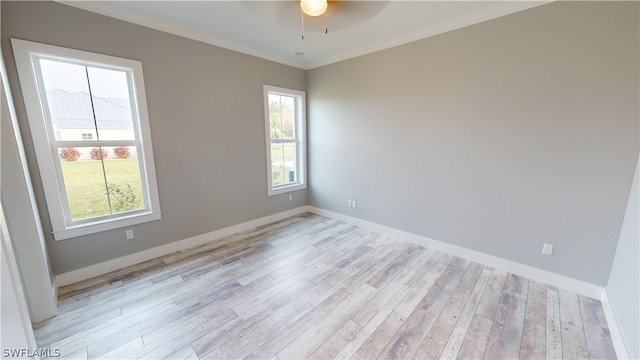 empty room featuring ceiling fan, crown molding, and light hardwood / wood-style floors