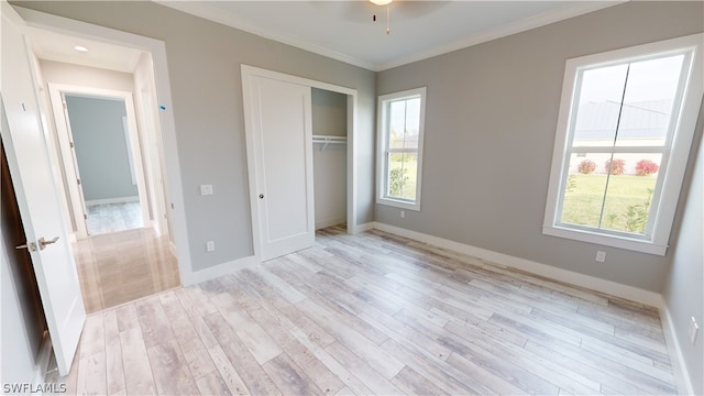 unfurnished bedroom featuring ornamental molding, ceiling fan, a closet, and light hardwood / wood-style flooring