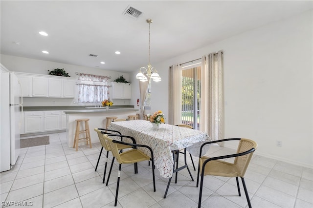 dining space with an inviting chandelier and light tile floors