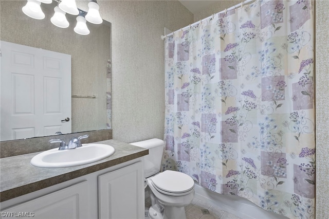 bathroom with toilet, tile flooring, and vanity