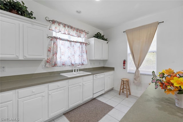 kitchen with sink, white cabinetry, light tile floors, and dishwasher