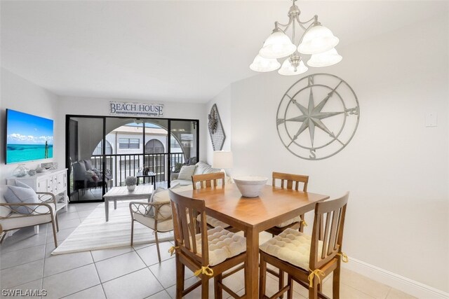 dining area with light tile floors and a notable chandelier