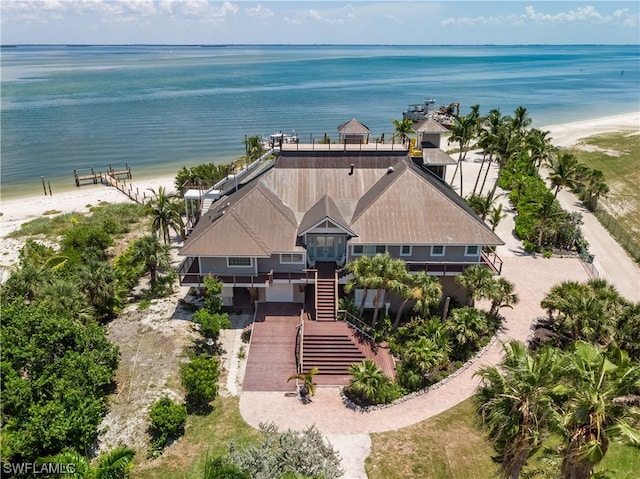 birds eye view of property featuring a beach view and a water view