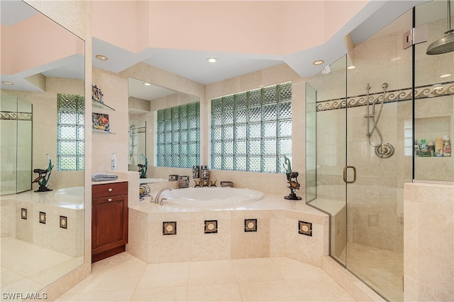 bathroom featuring plus walk in shower, tile patterned floors, and vanity