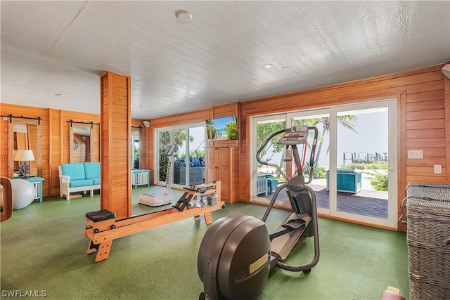 workout room featuring wood walls