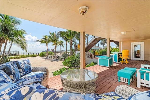 view of patio / terrace with a deck with water view