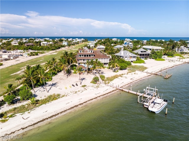 drone / aerial view with a water view and a beach view