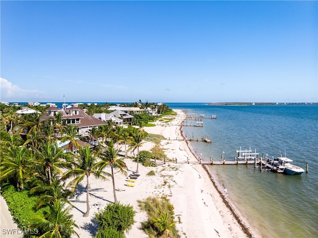 property view of water featuring a view of the beach and a boat dock