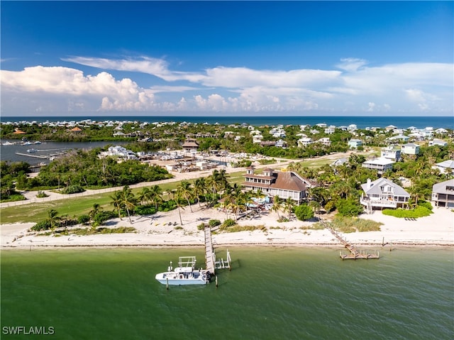 drone / aerial view featuring a beach view and a water view