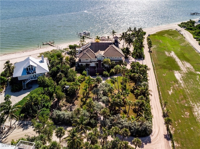 birds eye view of property featuring a water view and a beach view