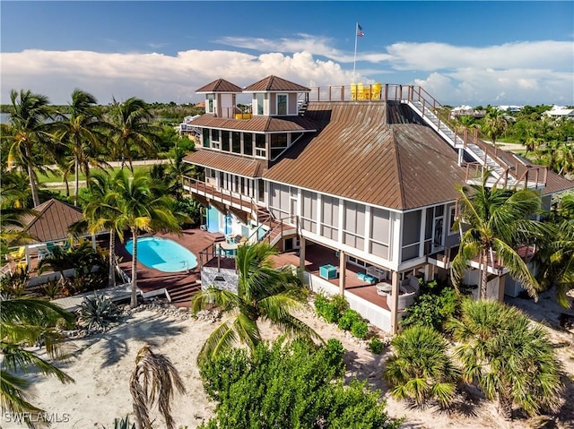 211 Kingfisher Dr, Captiva, FL 33924 - rear view of house featuring an outdoor pool, stairway, and a patio area