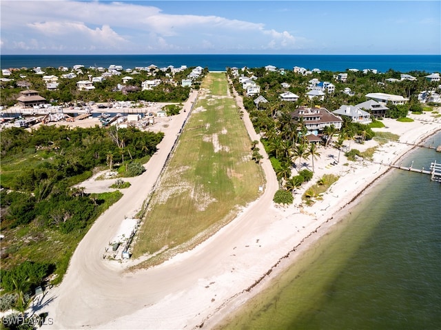 aerial view with a water view and a beach view