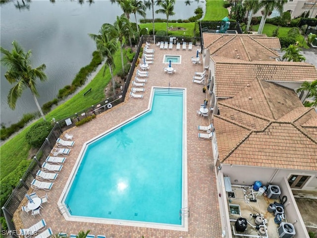 view of pool featuring a patio and a water view