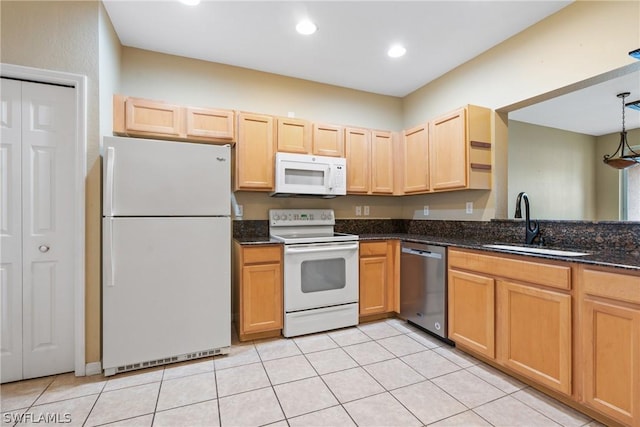 kitchen with light tile patterned flooring, sink, pendant lighting, white appliances, and dark stone counters