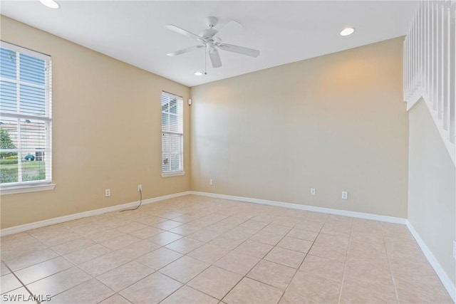 spare room featuring light tile patterned flooring and ceiling fan