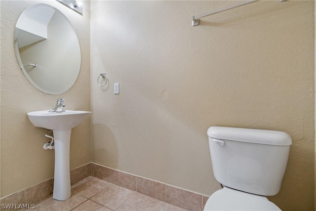 bathroom with tile patterned floors and toilet