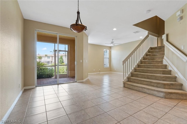 tiled foyer entrance with ceiling fan