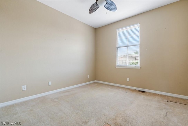 carpeted empty room featuring ceiling fan