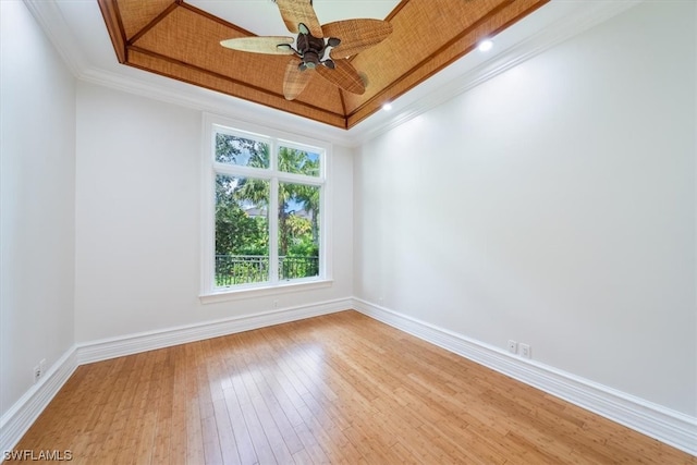 empty room featuring crown molding, ceiling fan, and light hardwood / wood-style flooring