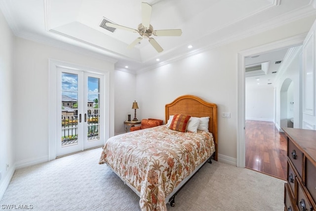 carpeted bedroom featuring ceiling fan, a raised ceiling, ornamental molding, and access to outside