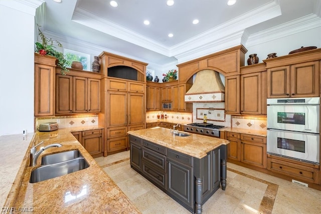 kitchen featuring sink, appliances with stainless steel finishes, backsplash, custom range hood, and light tile flooring