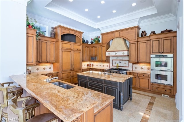 kitchen featuring light tile floors, a kitchen breakfast bar, appliances with stainless steel finishes, custom range hood, and tasteful backsplash