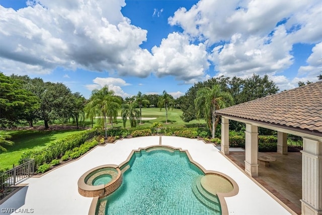 view of swimming pool featuring a patio area and an in ground hot tub