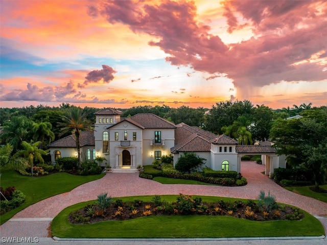 mediterranean / spanish-style house with a lawn