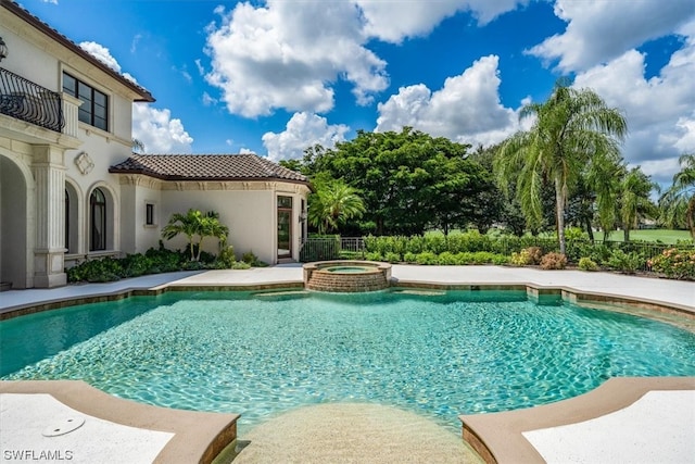 view of pool with an in ground hot tub