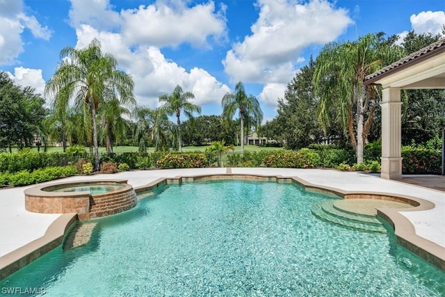 view of swimming pool with an in ground hot tub