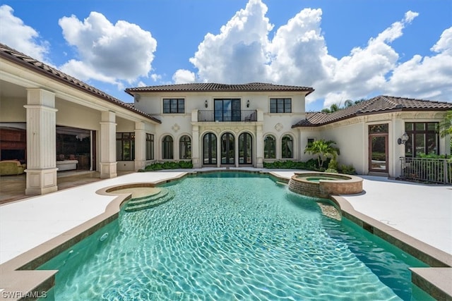 view of pool featuring a patio area and an in ground hot tub