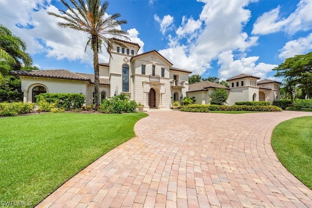 mediterranean / spanish-style house with a front yard