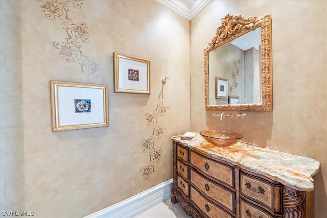 bathroom with ornamental molding and vanity