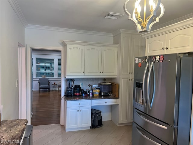 kitchen featuring a chandelier, tasteful backsplash, ornamental molding, light hardwood / wood-style flooring, and stainless steel fridge