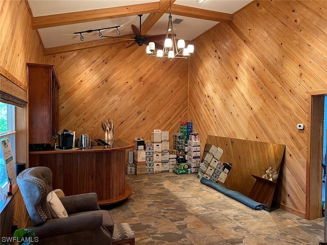 tiled home office featuring wood walls, a chandelier, rail lighting, and lofted ceiling with beams