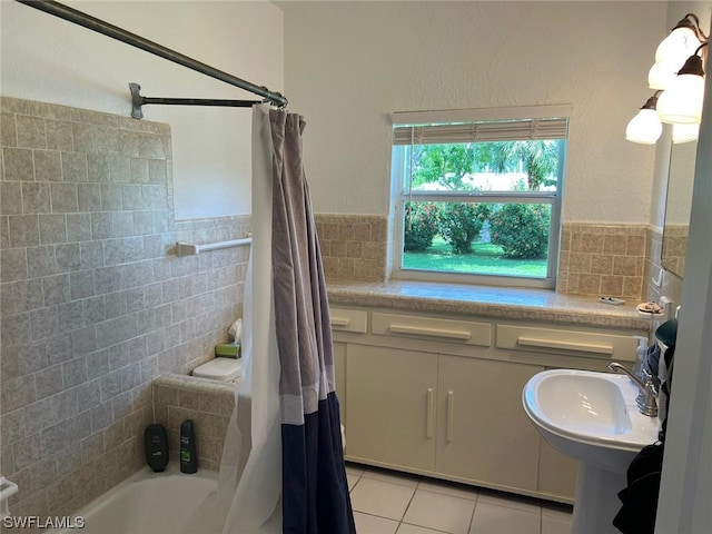 bathroom with sink, tile flooring, tile walls, and shower / bathtub combination with curtain