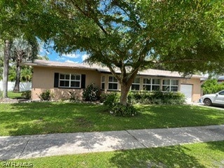 ranch-style home with a front yard